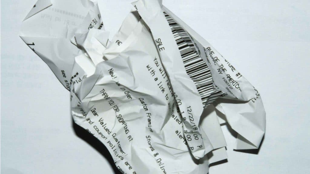 Crumpled paper receipts with barcodes and text, symbolising financial documents.