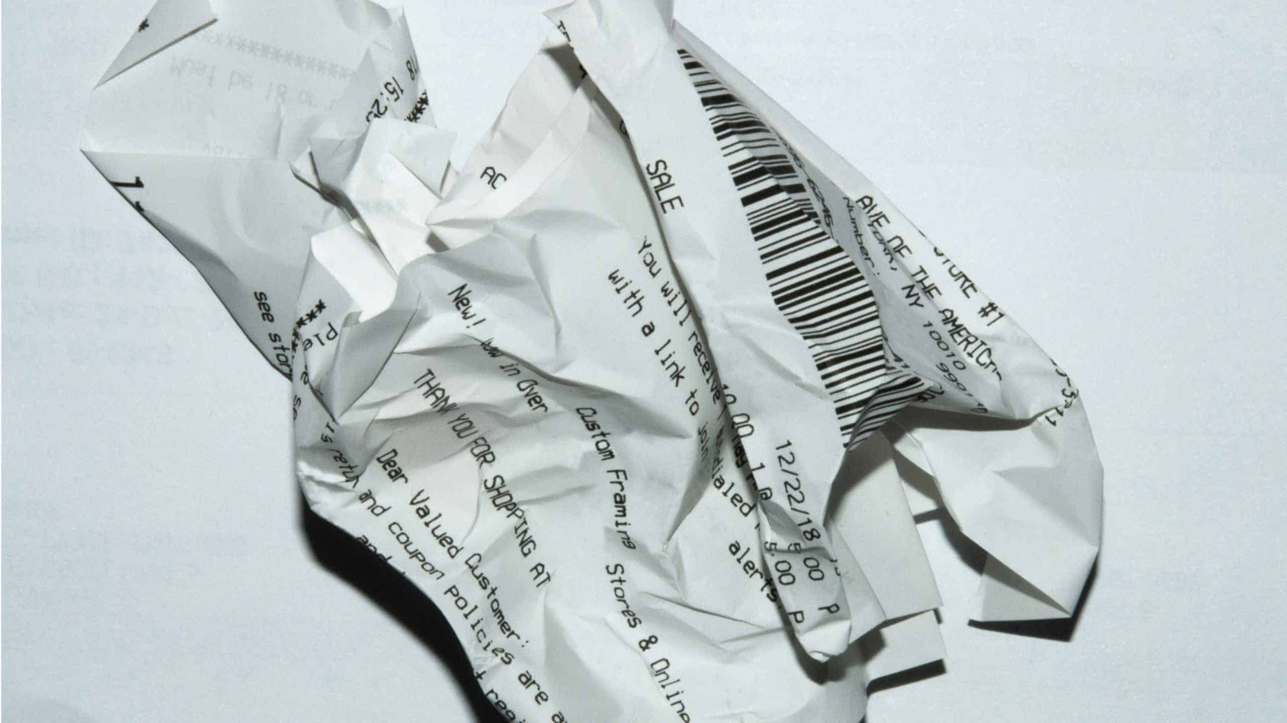 Crumpled paper receipts with barcodes and text, symbolising financial documents.